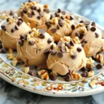 - 1 cup plain Greek yogurt - 1/2 cup peanut butter (creamy or crunchy) - 2 tablespoons honey or maple syrup - 1 teaspoon vanilla extract - 1/4 cup mini chocolate chips - 1/4 cup chopped nuts (optional: almonds, walnuts, or peanuts) - A pinch of sea salt Each ingredient plays a key role in making these frozen yogurt bites a treat. The Greek yogurt gives a creamy base. Peanut butter adds a rich, nutty flavor. Honey or maple syrup sweetens the mix. Vanilla extract adds warmth and depth. Mini chocolate chips bring a burst of sweetness. Chopped nuts add crunch, but they are optional. A pinch of sea salt balances all the flavors. When selecting your ingredients, use high-quality ones for the best results. Opt for plain Greek yogurt for creaminess. Choose your favorite peanut butter, whether creamy or crunchy. Honey or maple syrup can add unique flavors based on your choice. This simple list makes it easy for anyone to whip up these delicious bites. With these ingredients, you can create a healthy snack that kids and adults will love! 1. In a mixing bowl, combine the Greek yogurt, peanut butter, honey, vanilla, and salt. 2. Stir the mixture well until it is smooth and creamy. 3. Gently fold in the mini chocolate chips and any chopped nuts you want. 4. Prepare a mini muffin tray by lining it with silicone or paper liners. 5. Spoon the yogurt mixture into each muffin liner, filling them about three-quarters full. 6. Lightly tap the tray on the counter to release any air bubbles. 7. Place the tray in the freezer. Let the bites freeze for at least 3 hours. 8. Once solid, pop the bites out of the tray. Store them in an airtight container in the freezer for up to one month. This easy step-by-step guide helps you create tasty frozen yogurt bites with rich flavors. You get a blend of creamy peanut butter and sweet chocolate in every bite. To get a smooth texture, mix the Greek yogurt and peanut butter well. Use a sturdy spoon to blend them until you see no lumps. This step is key to a creamy bite. When adding mini chocolate chips, fold them in gently. This keeps them evenly mixed throughout. If you stir too hard, you might break them apart. Air bubbles can ruin your bites. To avoid them, fill the muffin liners slowly. After filling, tap the tray lightly on the counter. This helps release any trapped air. You can present your yogurt bites in fun ways. Try placing them on a colorful platter. Adding extra mini chocolate chips and nuts around them makes a great display. For snacks or desserts, serve these bites with fresh fruit. Slices of banana or strawberries pair well. You can also enjoy them with a scoop of ice cream for a treat. {{image_2}} You can change the nut butter to suit your taste. Try almond butter or sunflower seed butter for a different flavor. Each nut butter adds its own twist to the bites. For sweeteners, honey works well, but you can also use agave syrup or even stevia. Each sweetener brings a unique taste level. Add fruits to the yogurt mix for more fun. Small pieces of strawberries or blueberries work great. They add color and flavor to your frozen treats. Want to spice things up? Add cinnamon or nutmeg for warmth. Just a pinch can change the whole taste. Vanilla extract is a classic, but almond or coconut extract can give a tasty twist. These little changes can make your yogurt bites stand out and feel special. To keep your yogurt bites fresh, store them in an airtight container. This prevents freezer burn. You can use a plastic or glass container. Always make sure the lid fits well. For the best taste, enjoy them within one month. After that, they may lose some flavor and texture. To thaw the frozen bites, take them out of the freezer. Let them sit at room temperature for about 10 minutes. This makes them easier to eat. If you're in a hurry, you can microwave them for about 5 seconds. Be careful not to melt them. Enjoy your tasty treats as a quick snack or dessert! Can I use non-dairy yogurt? Yes, you can use non-dairy yogurt. Look for options made from almond, coconut, or soy. These will work well in this recipe. Just ensure they are plain and unsweetened for the best taste. How long can these be stored in the freezer? You can store these yogurt bites in the freezer for up to one month. Keep them in an airtight container to maintain their flavor and texture. Are there any allergens to be aware of? Yes, this recipe contains common allergens. It has dairy from yogurt and nuts from peanut butter. If you have allergies, consider using alternatives like non-dairy yogurt or sunbutter. Can I omit the sweetener? Yes, you can omit the sweetener if you prefer. The peanut butter and yogurt have some natural sweetness. Try it first without sweetener and see if you like the taste. What substitutes can I use for chocolate chips? You can use carob chips, chopped dried fruit, or even small pieces of dark chocolate. Each option gives a unique taste and texture. Choose what you like best! You learned how to make easy and tasty yogurt bites. We covered ingredients, step-by-step prep, and tips for the best texture. You can swap ingredients and add flavors to fit your taste. Remember to store the bites right to keep them fresh. These yogurt bites are not just snacks; they can also be a fun dessert. Try them out and make them your own! Enjoy creating something new for you and your family.
