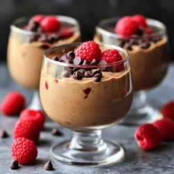For this Protein Cottage Cheese Chocolate Mousse, gather these key ingredients: - 1 cup cottage cheese - 1/4 cup unsweetened cocoa powder - 1/4 cup honey or maple syrup - 1 teaspoon vanilla extract - A pinch of salt You can add these optional ingredients for more depth: - 1/2 teaspoon instant coffee powder This coffee powder boosts the chocolate flavor without making it taste like coffee. To make your mousse look and taste even better, use these garnishes: - 1/4 cup dark chocolate chips - Fresh berries, such as raspberries or strawberries The chocolate chips add a nice crunch. Fresh berries provide a bright contrast in flavor and color. Start by gathering your ingredients. You will need: - 1 cup cottage cheese - 1/4 cup unsweetened cocoa powder - 1/4 cup honey or maple syrup - 1 teaspoon vanilla extract - 1/2 teaspoon instant coffee powder (optional) - A pinch of salt Next, grab your blender or food processor. This tool makes the mousse creamy and smooth. Add the cottage cheese, cocoa powder, honey (or maple syrup), vanilla extract, and salt to the blender. If you want deeper flavor, add the instant coffee powder. Blend everything on high speed until the mixture is smooth and creamy. Taste the mousse. If you want it sweeter, add a bit more honey or syrup. Blend briefly again to mix. Now, spoon the mousse into your favorite glasses or bowls. This is where the fun begins! Chill the mousse in the refrigerator for at least 30 minutes. This helps it firm up a bit. When you are ready to serve, top the mousse with dark chocolate chips. This adds a lovely touch. For a burst of freshness, add some berries like raspberries or strawberries on top. Enjoy your Protein Cottage Cheese Chocolate Mousse! To get a smooth mousse, blend the cottage cheese well. Use a high-speed blender or food processor. This step is key to avoid lumps. If you want it even creamier, try using small curd cottage cheese. Make sure to blend until the mixture is fluffy and silky. This gives your mousse that light feel. Taste your mousse after blending. If you want it sweeter, add more honey or maple syrup. Blend briefly again to mix it well. Remember, the sweetness can change based on your cocoa powder. Start with a small amount, and adjust to your liking. One big mistake is not blending enough. Lumps can ruin the texture. Another is skipping the chilling time. Letting it chill helps firm up the mousse. Don't forget to taste as you go. Overdoing the cocoa powder can make it bitter, so start with less. Lastly, ensure you use fresh ingredients for the best flavor. {{image_2}} You can play with flavors in your Protein Cottage Cheese Chocolate Mousse. Try adding mint extract for a fresh twist. Just a drop will do. Orange zest can give a bright and zesty flavor. You can also mix in a spoon of peanut butter for a nutty taste. Each option brings a new experience to your dessert. You can swap honey or maple syrup for stevia or agave syrup. This change cuts calories but keeps the sweetness. Using low-fat cottage cheese can also make it lighter. If you want a richer taste, choose Greek yogurt instead of cottage cheese. These small swaps can help fit your diet needs while enjoying this treat. Serve this mousse in clear glasses for a stunning display. Layer it with yogurt and granola for a parfait. This adds crunch and makes it more fun. You can also use it as a filling in desserts like cupcakes. Top it with fresh berries for a colorful touch. Enjoying it this way makes it feel special and gourmet. To store leftover mousse, place it in an airtight container. Make sure to cover it well. This keeps the mousse fresh and prevents it from absorbing other smells in the fridge. If you plan to eat it later, store it right away. You can freeze the mousse if you have lots left. Use freezer-safe containers or ice cube trays. Pour the mousse into these containers, leaving some space for it to expand. When you want to eat it, thaw it in the fridge overnight. Do not refreeze after thawing. The mousse lasts up to five days in the fridge. Keep an eye on it for any changes in smell or texture. If it looks or smells off, throw it away. In the freezer, it can last for about three months. Always label the container with the date. This helps you keep track of how long it has been stored. Yes, you can use low-fat cottage cheese. It still gives a creamy texture. The taste will be slightly lighter but still delicious. If you want a richer flavor, regular cottage cheese works best. The mousse lasts about three days in the fridge. Be sure to store it in an airtight container. This keeps it fresh and tasty. If you notice any change in smell or look, it’s best to toss it out. Yes, you can make this mousse a day ahead. Just chill it in the fridge until you are ready to serve. This helps the flavors blend and improves the texture. Prepare it early for a stress-free dessert! This blog post covered all you need for a great mousse. We discussed key ingredients, step-by-step instructions, helpful tips, and tasty variations. Remember, the right texture and flavor can make your mousse standout. Store it well to keep it fresh for longer. Play with flavors to find your favorite twist. Now, you’re ready to make a perfect mousse for any occasion. Enjoy the process and have fun experimenting!