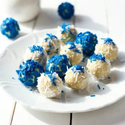 - 1 cup white chocolate chips - ½ cup cream cheese, softened - 1 teaspoon vanilla extract - ½ cup crushed blue cornflakes - ½ cup shredded coconut - ¼ cup blue sprinkles - A pinch of sea salt For the best flavor, choose high-quality white chocolate. Brands like Guittard or Ghirardelli work well. You can swap cream cheese for vegan cream cheese. If you want gluten-free truffles, ensure your cornflakes are certified gluten-free. - Microwave-safe bowl - Mixing bowl - Cookie scoop or your hands - Parchment paper These tools help you make the process easy and fun. The microwave-safe bowl is essential for melting the chocolate. The mixing bowl lets you combine the creamy filling. A cookie scoop helps form even truffles, while parchment paper keeps your truffles from sticking. {{ingredient_image_1}} To start, grab a microwave-safe bowl. Place the white chocolate chips inside. Heat them in 30-second bursts. After each burst, take the bowl out and stir. Keep this up until the chocolate is smooth. This method helps prevent burning. If you see lumps, keep mixing until they melt. The goal is a silky texture. Next, take your cream cheese. It’s important to let it soften first. This makes mixing easier. Place the cream cheese and vanilla extract in a mixing bowl. Blend them until the mixture looks creamy. This step is key for a smooth truffle. No one wants lumps in their treats. Now we get to the fun part! Use a small cookie scoop to form balls. Each ball should be about 1 inch wide. If you don't have a scoop, use your hands. Roll the truffles gently until they are round. For coating, first roll each truffle in crushed blue cornflakes. Make sure they are fully covered. This gives a nice crunch. Next, roll them in shredded coconut. This step adds a snowy look. Finally, sprinkle blue sprinkles on top for a festive touch. Place the finished truffles on a tray lined with parchment paper. Chill them in the fridge for about 15 to 20 minutes. This helps them set nicely. Enjoy your beautiful Blue Christmas Truffles! To make your blue Christmas truffles shine, try these ideas: - Platter Presentation: Place truffles on a colorful platter. Use festive decorations like pinecones or tinsel. - Garnish: Add extra shredded coconut or blue sprinkles around the truffles. This creates a beautiful effect. - Individual Wrapping: Wrap each truffle in clear cellophane. Tie with a blue ribbon for a lovely gift. Pair these truffles with other treats for a festive touch: - Serve with peppermint bark for a minty twist. - Offer alongside gingerbread cookies for a classic combo. Watch out for these common pitfalls: - Overheating the Chocolate: Heat white chocolate in short bursts. Stir often to prevent burning. - Not Chilling the Mixture Long Enough: Chill the mixture for at least 30 minutes. This makes rolling easier and neater. When is the best time to serve blue Christmas truffles? - Serve them at holiday parties or family gatherings. They make great snacks for festive movie nights. For ideal accompaniments: - Offer with hot cocoa or coffee for a cozy treat. - Pair with sparkling cider or festive cocktails for a fun twist. Pro Tips Chill the Mixture: Make sure to chill the mixture long enough so it's easy to roll into balls without being too sticky. Experiment with Coatings: Feel free to mix up your coatings; try crushed nuts or different colored sprinkles for a unique twist. Use Quality Ingredients: Using high-quality white chocolate will enhance the flavor of your truffles significantly. Make Ahead: These truffles can be made a day in advance, allowing the flavors to meld together beautifully. {{image_2}} You can change the taste of your Blue Christmas Truffles easily. Try adding peppermint extract for a fresh twist. Just a few drops will give your truffles a festive kick. You can also mix in other flavors, like almond or orange zest, to surprise your taste buds. Incorporating different mix-ins adds texture. Consider adding chopped nuts or dried fruit. These ingredients will give the truffles a unique crunch. You can also use colored chocolate chips to make them even more fun! If you want to make vegan or dairy-free truffles, swap the cream cheese for a vegan cream cheese. Use dairy-free chocolate chips instead of white chocolate chips. This way, everyone can enjoy these tasty treats. For a gluten-free option, ensure all your ingredients are certified gluten-free. The blue cornflakes can often contain gluten, so look for gluten-free brands. This way, no one misses out on these delicious truffles. You can easily adjust these truffles for other holidays. For Valentine's Day, use pink or red sprinkles and heart-shaped molds. For Halloween, try orange and black sprinkles with a pumpkin flavor. Just switch the colors and ingredients, and your truffles will fit any holiday theme! To keep your Blue Christmas Truffles fresh, store them in an airtight container. Place parchment paper between layers to avoid sticking. This method helps maintain their texture and flavor. The ideal temperature for storage is between 32°F and 40°F (0°C and 4°C). Avoid leaving them out at room temperature for long. These truffles can last up to one week in the fridge. If you want to store them longer, you can freeze them. Wrap each truffle in plastic wrap, then place them in a freezer-safe bag. This helps keep the flavors intact. They can last for up to three months in the freezer. For a festive touch, use clear cellophane bags tied with a ribbon. You can also use decorative boxes with colorful tissue paper. This makes your truffles look appealing. Before gifting, store the truffles in the fridge to keep them fresh. Make sure to let your friends know how to store them for the best taste. You can use yogurt-covered pretzels or vanilla candy melts instead. Both options work well as a base. Simply melt the alternative in the same way as white chocolate. Then combine it with the softened cream cheese and vanilla extract. This keeps the truffles creamy and delicious. Yes, you can use many colors! Try red or green food coloring in the chocolate mix. You can also use colored sprinkles to match different holidays. For a fun twist, think about using pastel colors for spring or bright colors for summer. To gift truffles, consider using small boxes or clear bags. Make them festive with ribbons or labels. You can place them in a decorative tin or on a pretty plate. Adding a handwritten note can make it extra special. In this blog post, we explored how to make blue Christmas truffles. We covered the key ingredients, steps for preparation, and tips for avoiding common mistakes. Remember to use quality ingredients for the best taste. Get creative with flavors and decorations to suit your style. Store your truffles properly to keep them fresh. With these insights, you can create fun and festive treats for yourself and others. Enjoy making and sharing your blue truffles this holiday season!